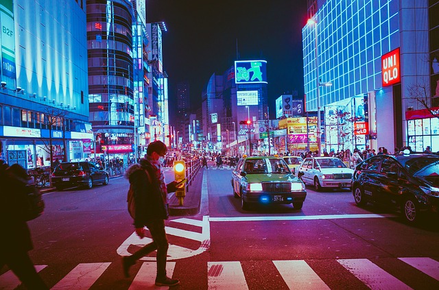 A close up of a busy city street in Osaka at night.